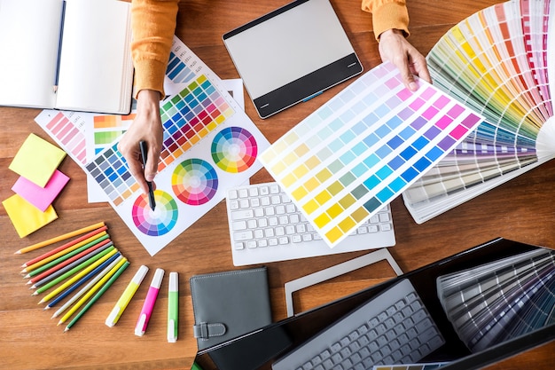 Image of creative graphic designer working on color selection and drawing on graphics tablet Premium Photo